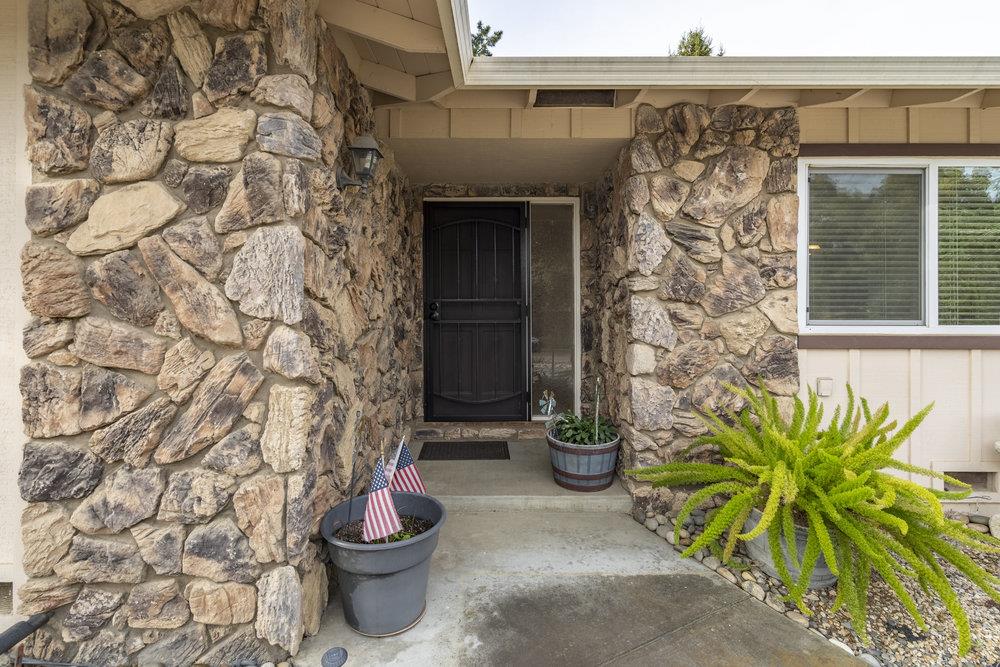 140 Rays Circle Hollister, CA 95023 - Photo 4 of 31 a front view of a house with a potted plant and a bench