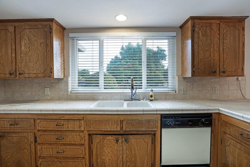 140 Rays Circle Hollister, CA 95023 - Photo 9 of 31 a kitchen with granite countertop cabinets sink and window