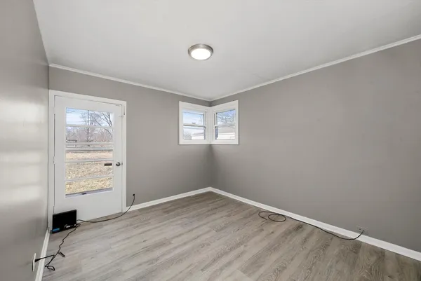 an empty room with windows and closet