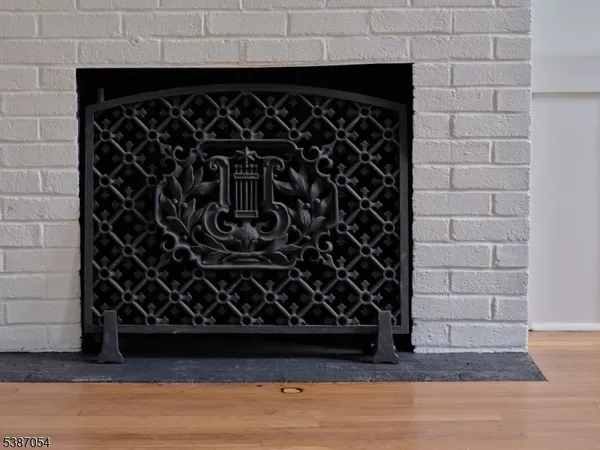 a view of a hallway with wooden floor and closet