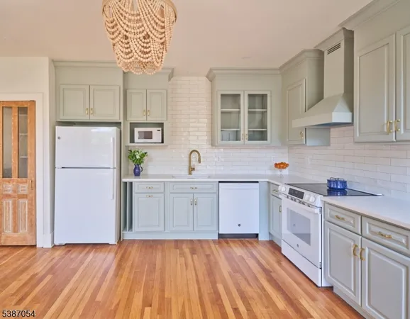a kitchen with a sink a refrigerator a stove and cabinets