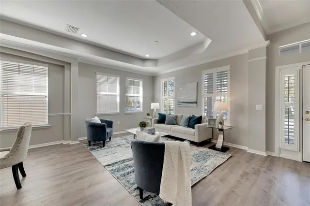 a living room with furniture and a wooden floor