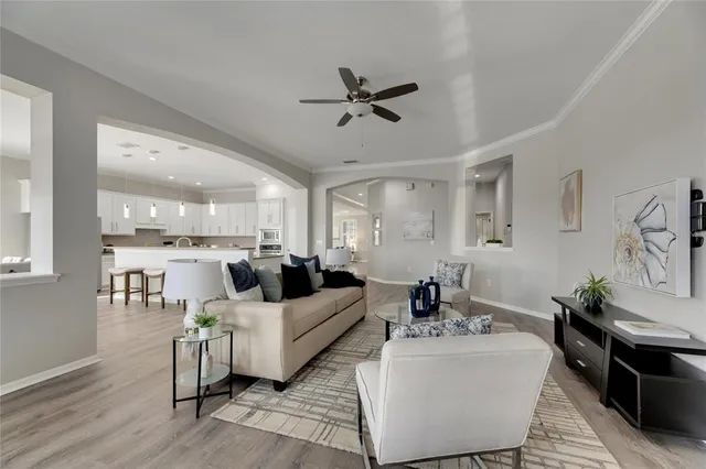 a kitchen with refrigerator and chairs