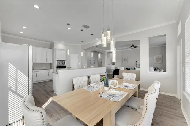 a large kitchen with kitchen island a sink and a refrigerator