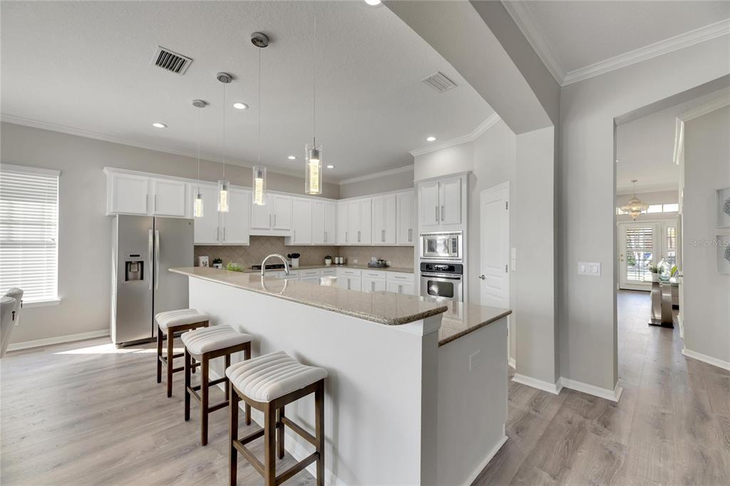528 Islebay Drive Apollo Beach, FL 33572 - Photo 24 of 98 a kitchen with refrigerator and chairs
