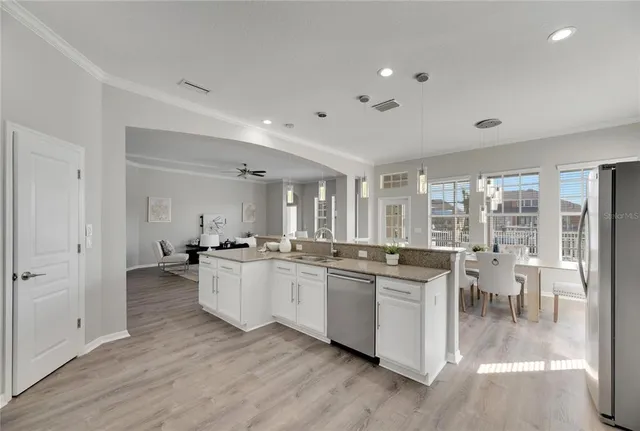 a view of a livingroom with wooden floor and flat screen tv