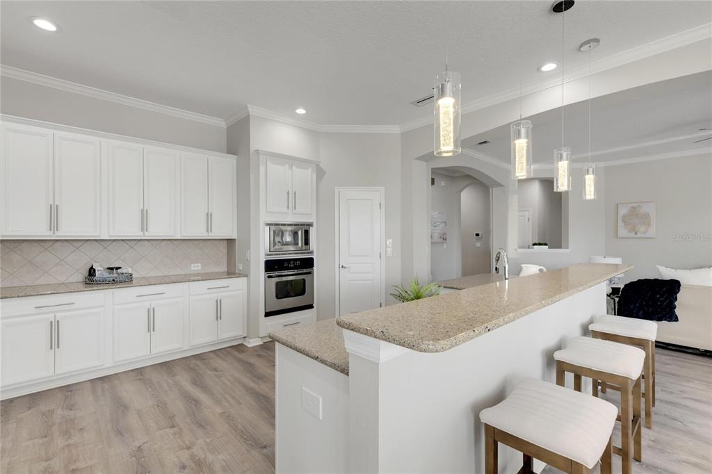 528 Islebay Drive Apollo Beach, FL 33572 - Photo 30 of 98 a large kitchen with kitchen island a sink and a refrigerator