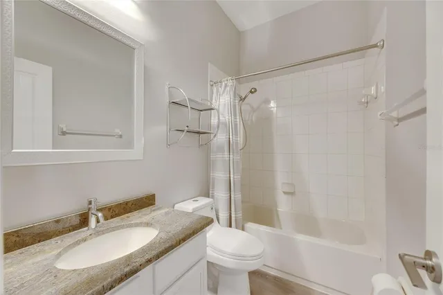 a bathroom with a sink vanity and mirror