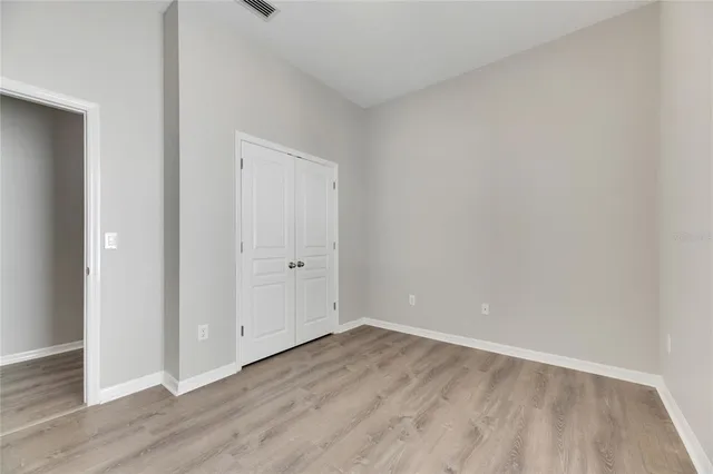 a view of a patio with a table chairs and wooden floor