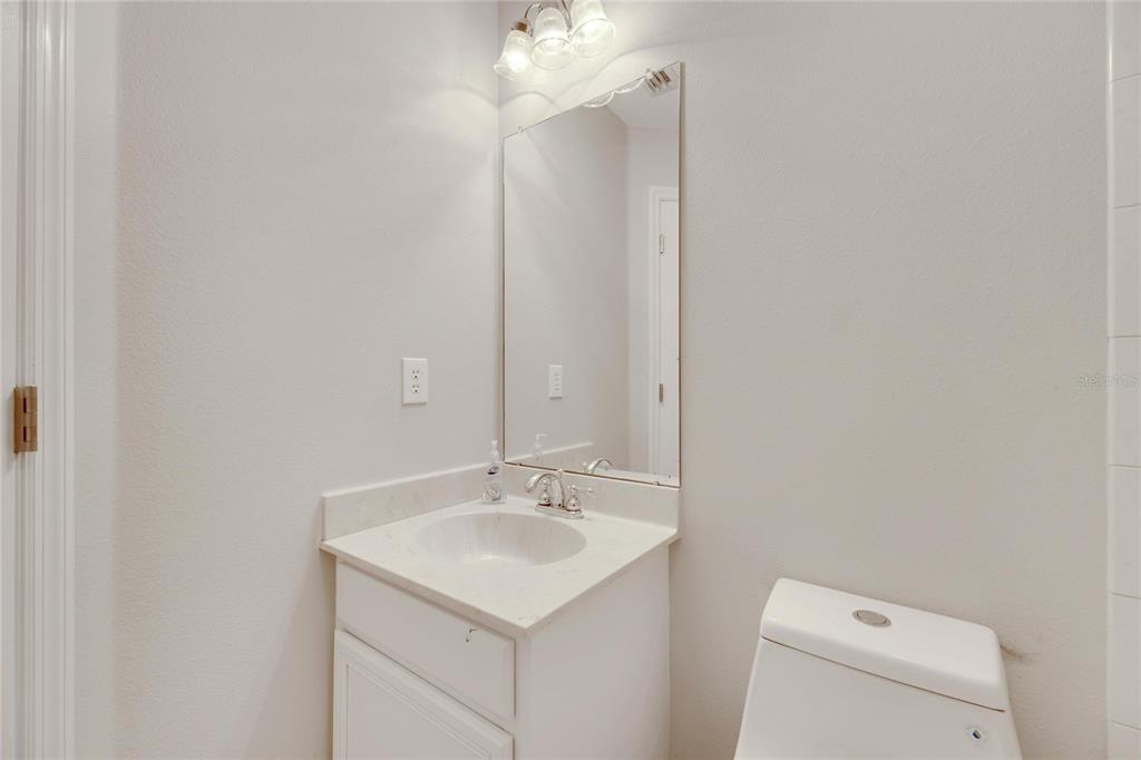 528 Islebay Drive Apollo Beach, FL 33572 - Photo 65 of 98 a bathroom with a sink a toilet and a mirror