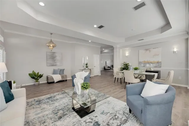 a living room with furniture and wooden floor