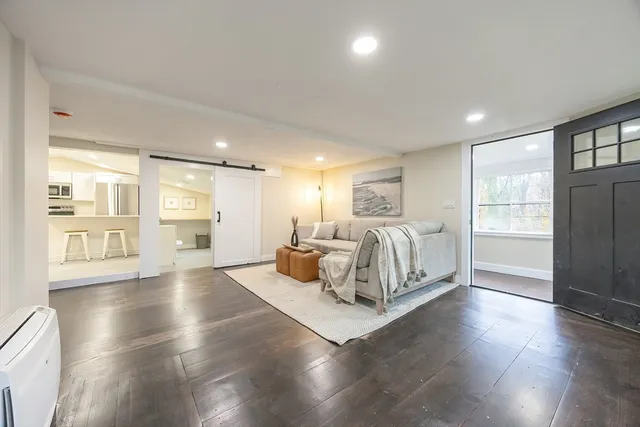 a spacious bedroom with a bed and a large window