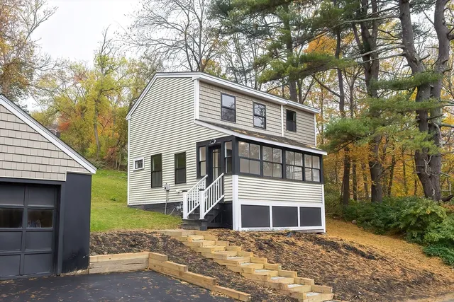 a front view of a house with a garden