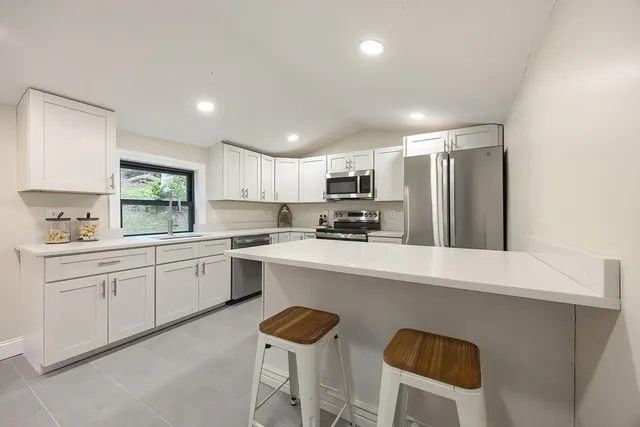 a kitchen with cabinets and window