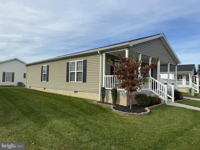 a front view of a house with a garden and porch