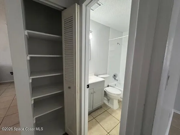 a bathroom with a granite countertop toilet and a shower