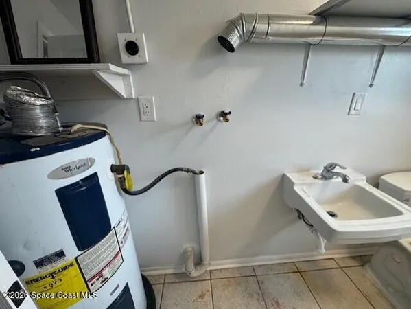 a bathroom with a sink toilet and mirror