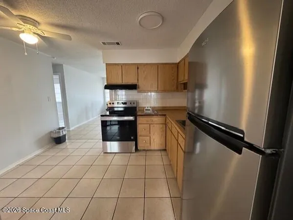 a kitchen with stainless steel appliances a refrigerator sink and cabinets