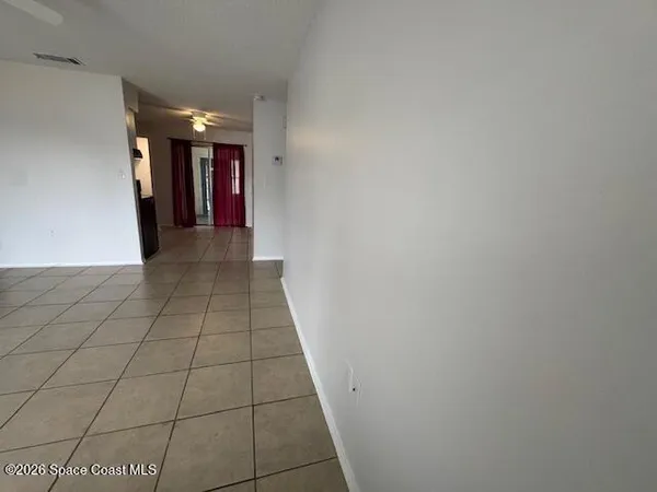 a view of hallway with a window and a fireplace
