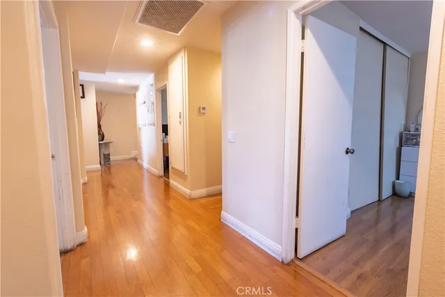 a view of a hallway with wooden floor