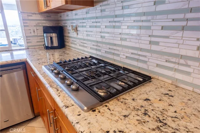 a stove top oven sitting inside of a kitchen