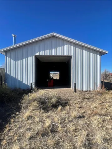 a view of a house with wooden fence