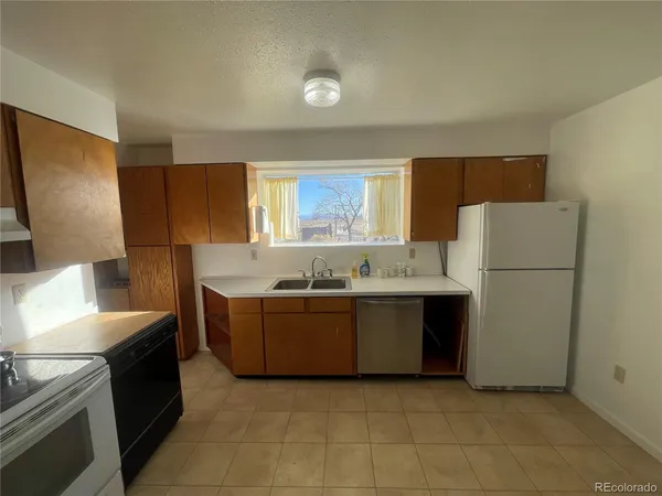 a large kitchen with a cabinets and white stainless steel appliances
