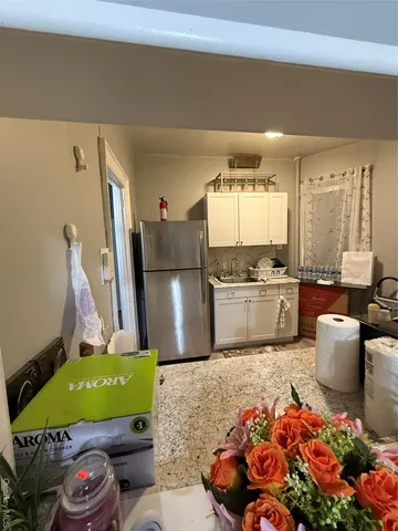 a kitchen with stainless steel appliances kitchen island granite countertop a refrigerator and a stove