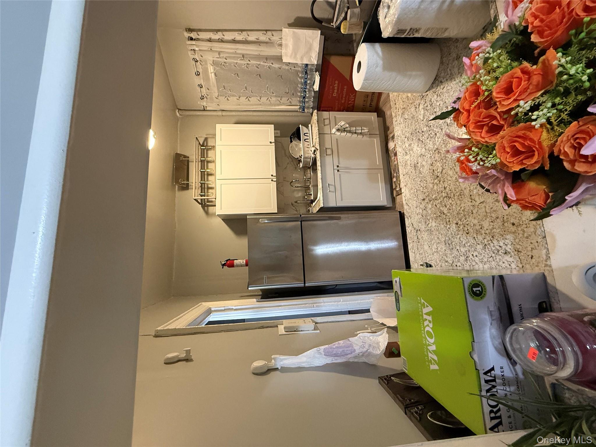 950 Hoe Avenue, Unit 4D Bronx, NY 10459 - Photo 2 of 8 a kitchen with stainless steel appliances kitchen island granite countertop a refrigerator and a stove