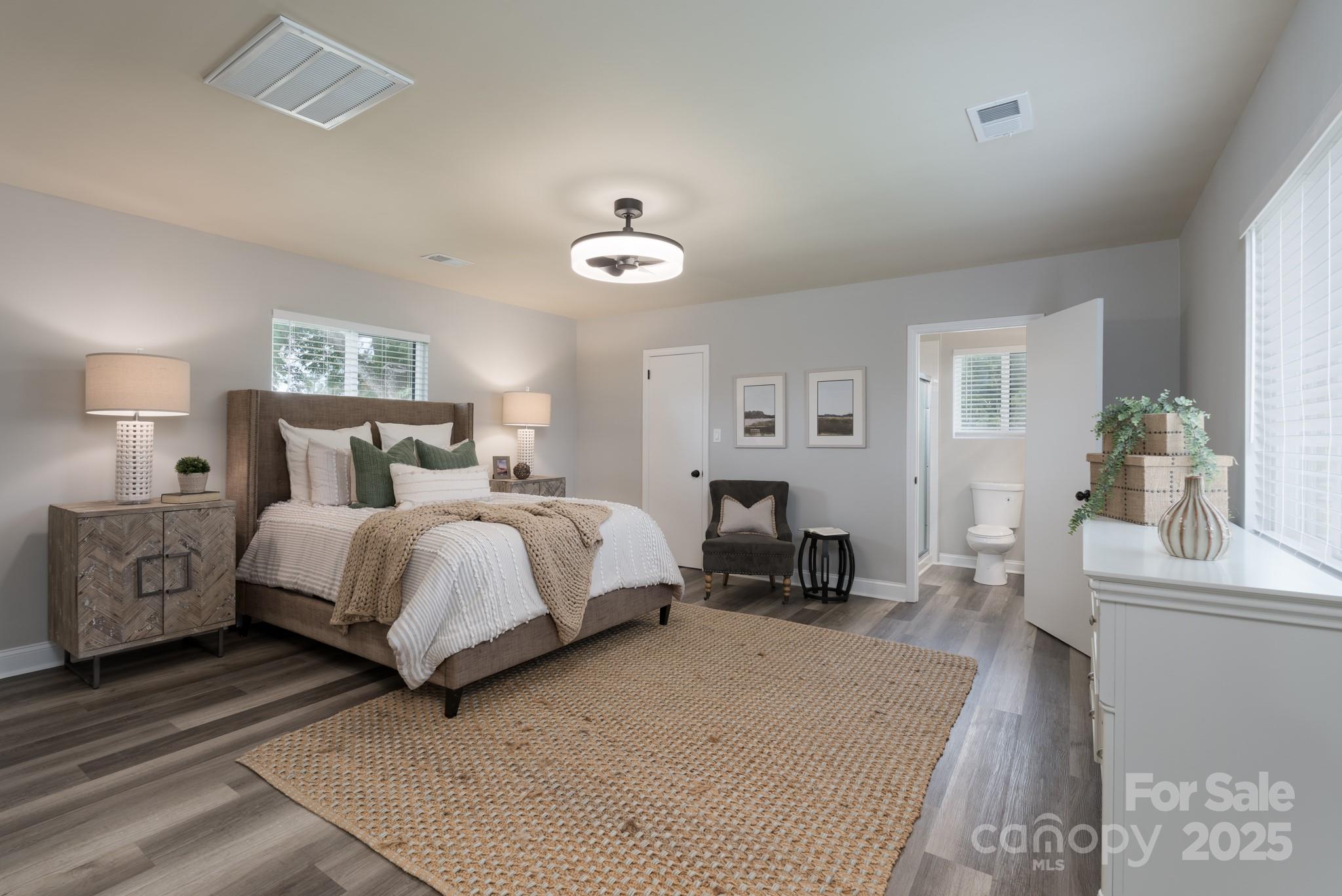 6211 Rock Island Road Charlotte, NC 28278 - Photo 27 of 36 a bedroom with a large bed and a chandelier