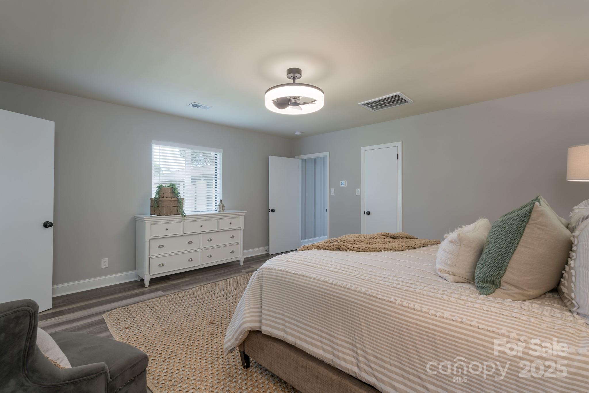 6211 Rock Island Road Charlotte, NC 28278 - Photo 28 of 36 a bedroom with a bed and a chair