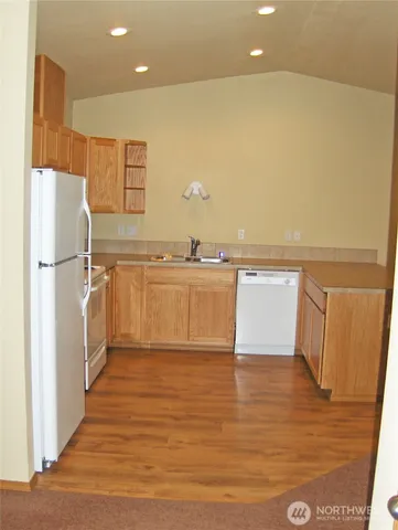 a view of a kitchen with wooden floor