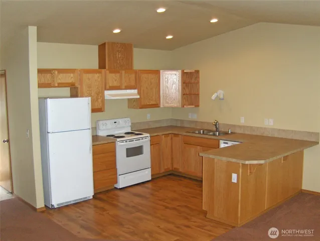 a kitchen with a stove a sink and a refrigerator