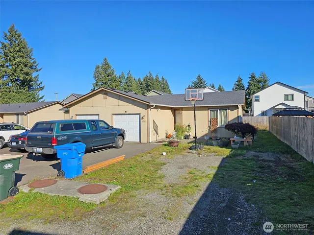 a view of a house with backyard and sitting area