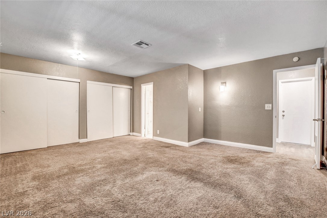 4367 South Mojave Road Las Vegas, NV 89121 - Photo 27 of 53 A spacious, naturally illuminated room featuring wall-mounted lighting and generous closet space.