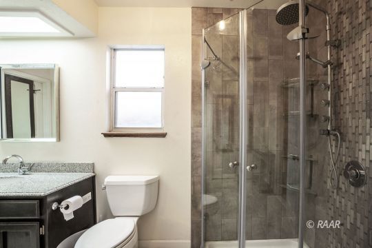 532 Amanda Street Ridgecrest, CA 93555 - Photo 20 of 35 a bathroom with a granite countertop sink toilet a mirror and shower