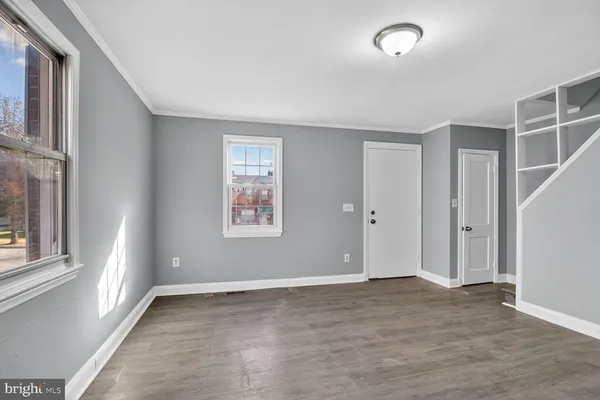 an empty room with windows and closet