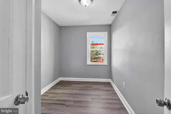 a view of hallway with wooden floor