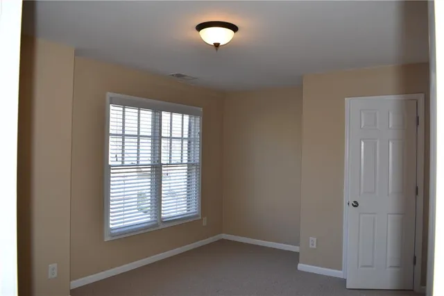 a view of room with window and ceiling fan