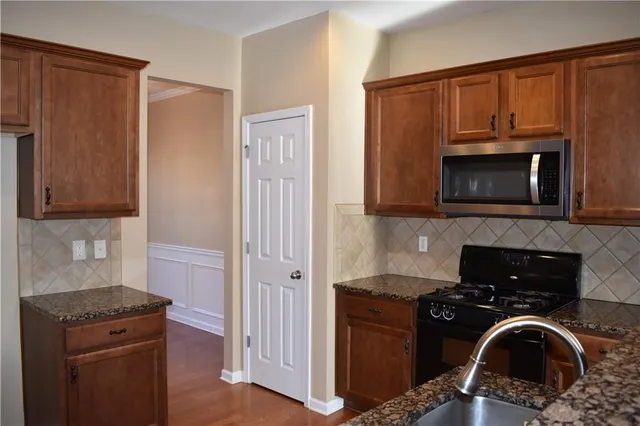 a kitchen with a stove and a microwave