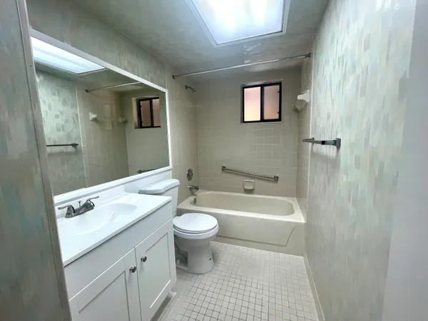 a view of a house with a tree in front of it