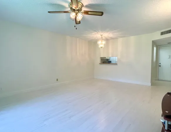 an empty room with a empty space and a ceiling fan