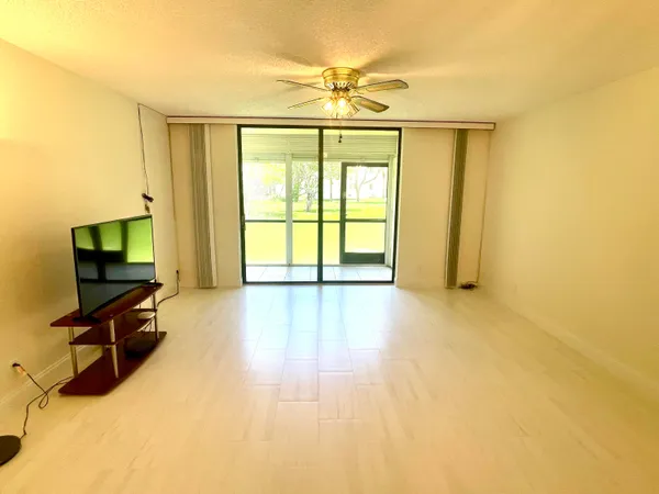 a view of a room with wooden floor and furniture