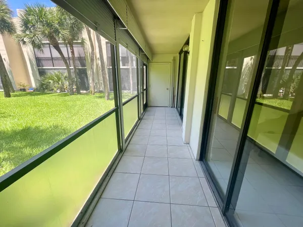 a view of a room with a ceiling fan and window