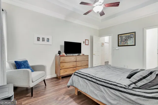 a bedroom with a bed and a television