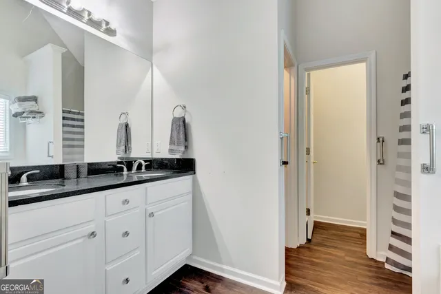 a bathroom with a double vanity sink and a mirror