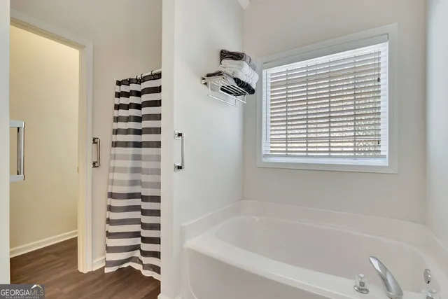 a bathroom with a bathtub and a shower