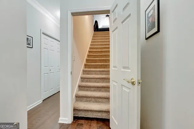 a view of a hallway with wooden floor and entryway