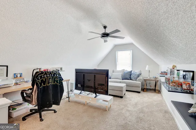 a view of a livingroom with furniture and a ceiling fan