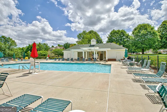 a view of a house with entertaining space and a trees